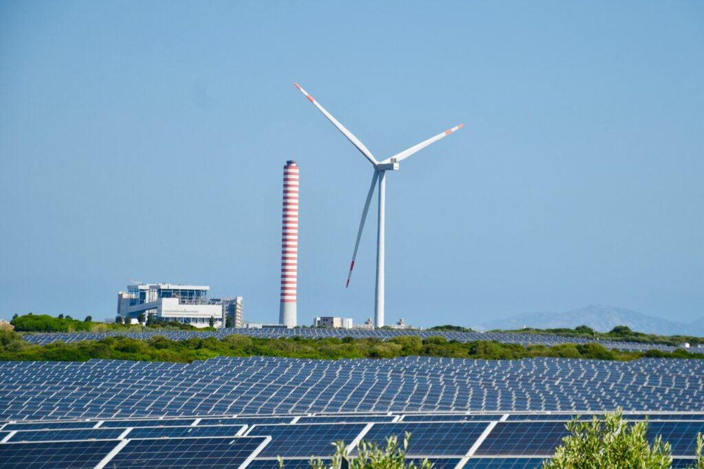 A wind farm with a wind turbine in the background